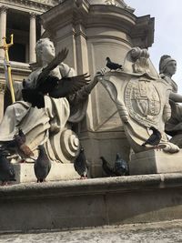 Low angle view of statue against historic building