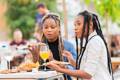 Women in traditional clothing at table