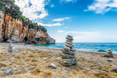 Scenic view of milopotamos beach in pelion in greece with pebbles beach castles against dramatic sky