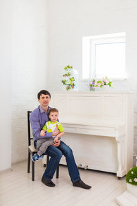 Mother and son sitting on floor