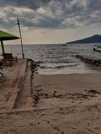 Scenic view of beach against sky during sunset