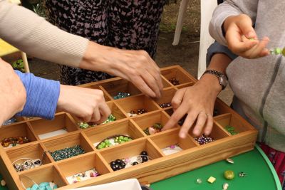 Cropped image of people making jewelry