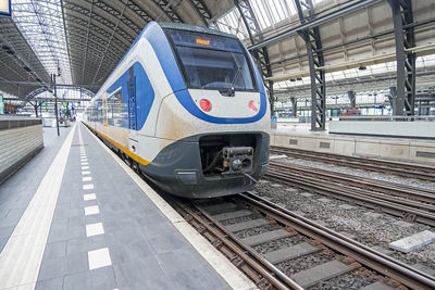 Train ready for departure on an empty central station in amsterdam netherlands 