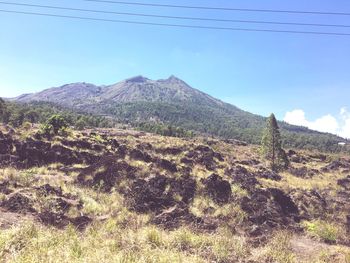 View of countryside landscape against mountain range