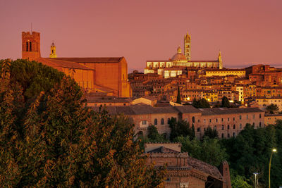 Panoramic view of buildings against sky at sunset