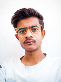 Portrait of young man against white background