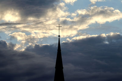 Low angle view of silhouette building against sky