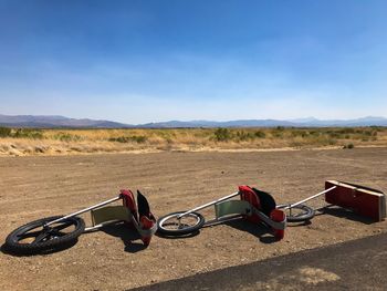 Bicycles on land against sky