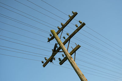 Low angle view of electricity pylon against sky