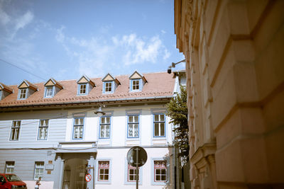 Low angle view of buildings in town against sky