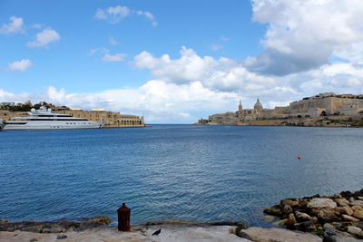 Scenic view of sea and buildings against sky