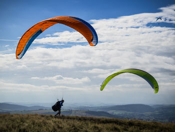 Man paragliding against sky