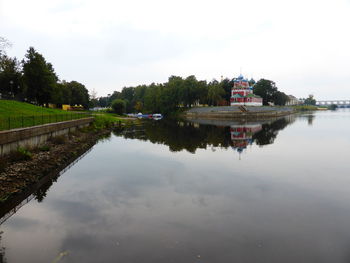 Scenic view of lake by building against sky