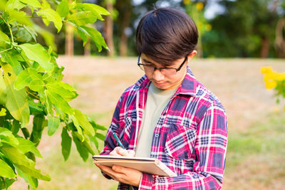 Boy holding plant