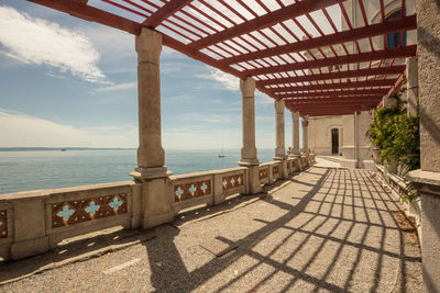 View of terrace over sea against cloudy sky