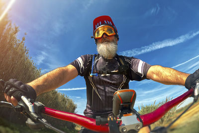 Low angle view of man riding bicycle