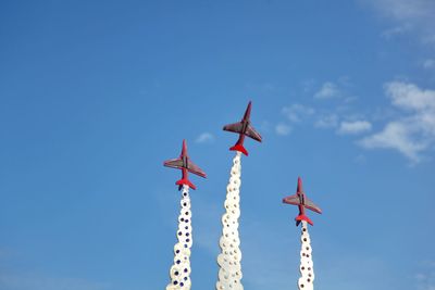 Low angle view of airplane flying against sky