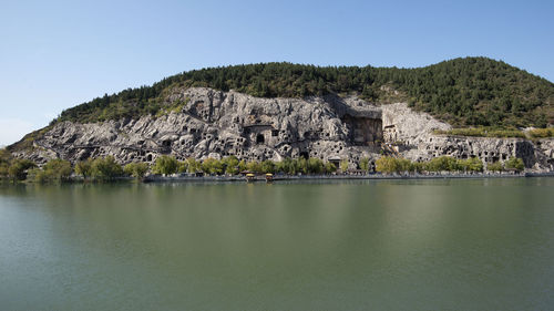 Scenic view of lake and mountains against clear sky