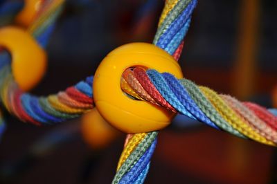 Close-up of multi colored rope in yellow circle