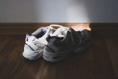 Close-up of shoes on hardwood floor