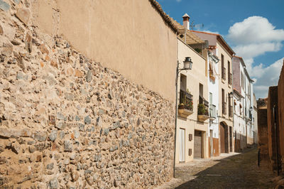 Street amidst buildings in town against sky