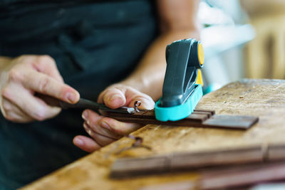 Midsection of man working in workshop