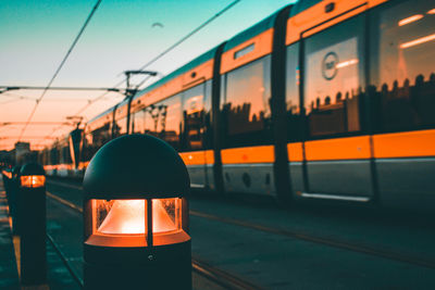 Train on railroad station platform during sunset