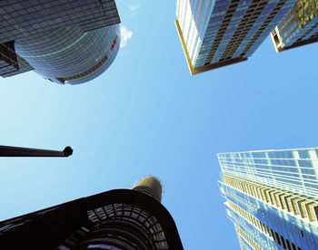 Low angle view of buildings against clear blue sky