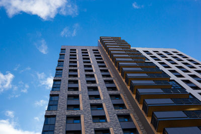 Low angle view of modern building against blue sky