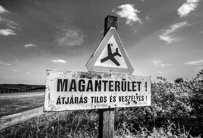 Low angle view of signboard against sky