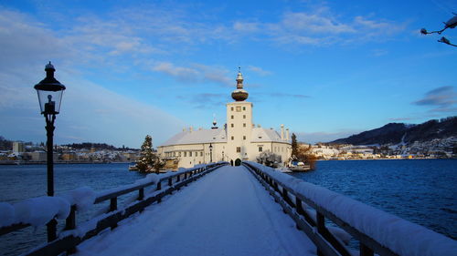 Snow covered buildings against sky