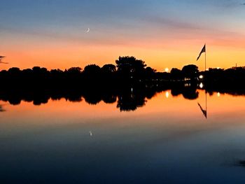 Scenic view of lake against sky at sunset