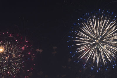 Low angle view of firework display at night