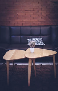 Empty chair and table against wall at home