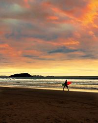 Scenic view of beach against sky during sunset