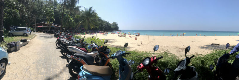 People at beach against sky