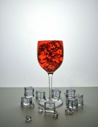 Close-up of wine glass on table against white background