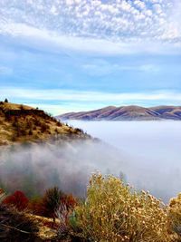 Scenic view of lake by mountain against sky