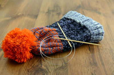 Close-up of knit hat on wooden table