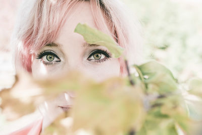 Close-up portrait of woman by plants