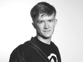 Portrait of confident young man against white background