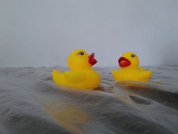 Close-up of yellow toys on bed