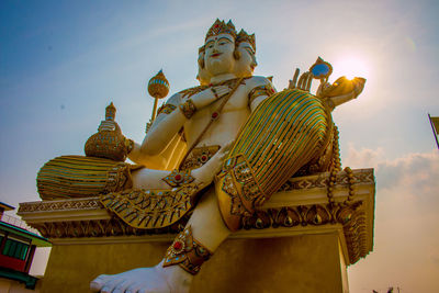 Low angle view of statue against building against sky