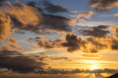 Low angle view of dramatic sky during sunset