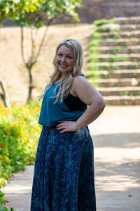 Portrait of smiling young woman standing outdoors