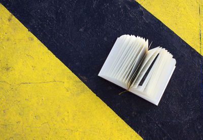 High angle view of book on striped road