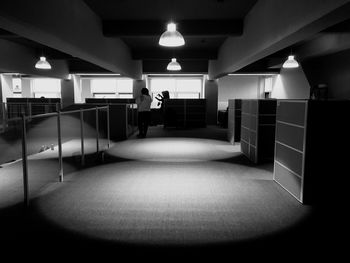 Man standing in illuminated corridor