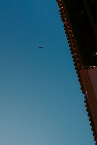 Low angle view of buildings against clear blue sky
