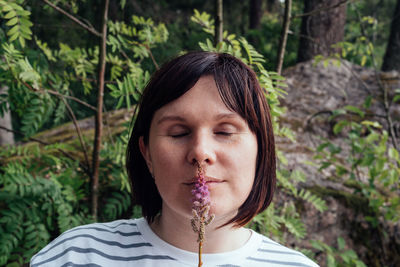 Portrait of a woman with closed eyes in nature, in the forest. alone with nature. 