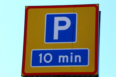 Close-up of sign against blue background